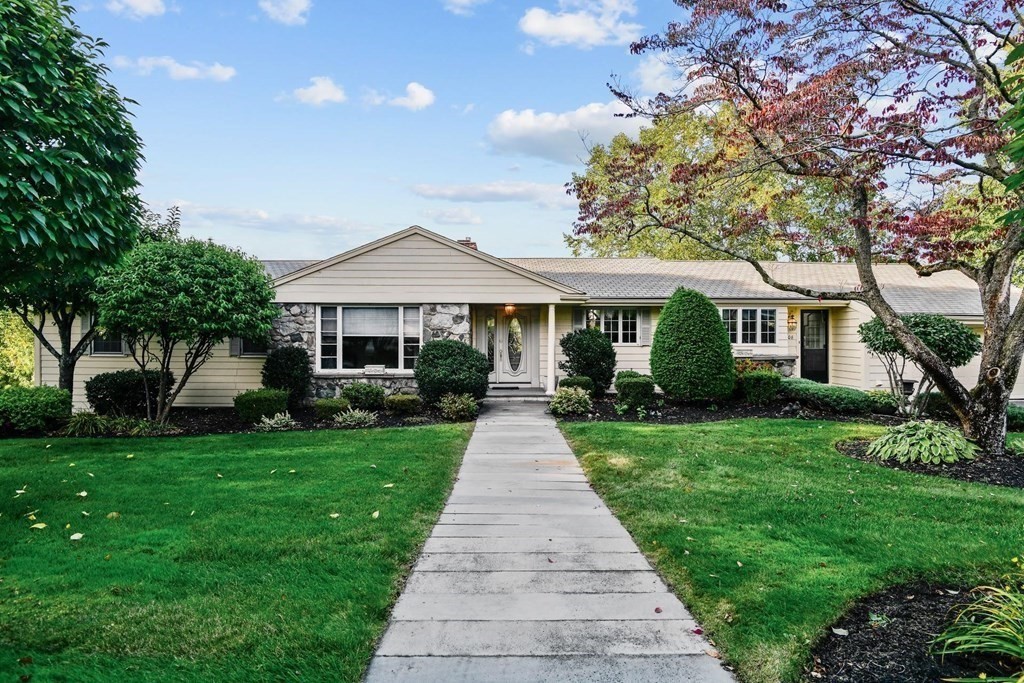 a front view of a house with yard porch and garden