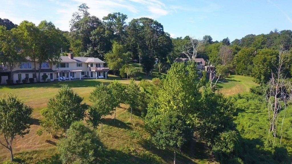 106 Forbes Road Milton, MA 02186 - Photo 15 of 27 a view of a swimming pool and trees in the background