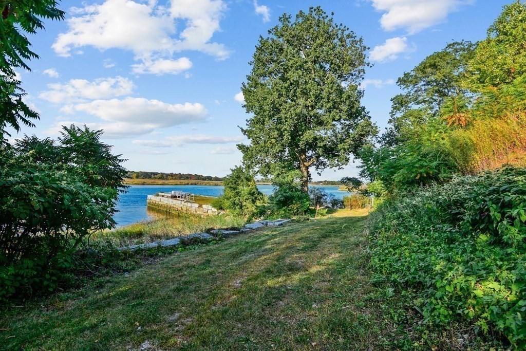 106 Forbes Road Milton, MA 02186 - Photo 17 of 27 a view of a house with a swimming pool and a yard