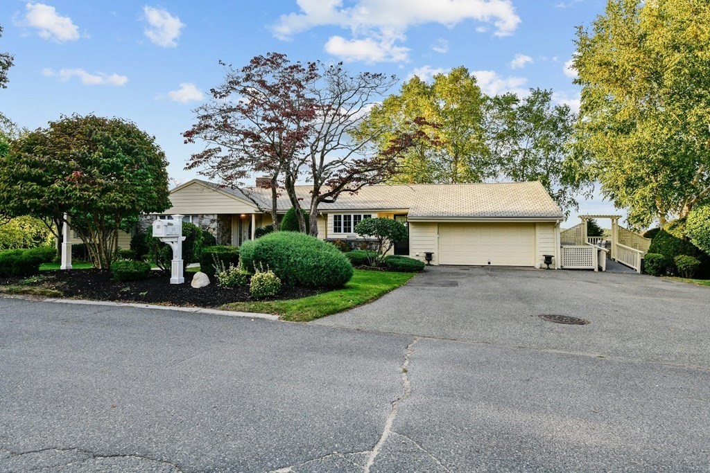 106 Forbes Road Milton, MA 02186 - Photo 2 of 27 a view of a house with a yard and garage