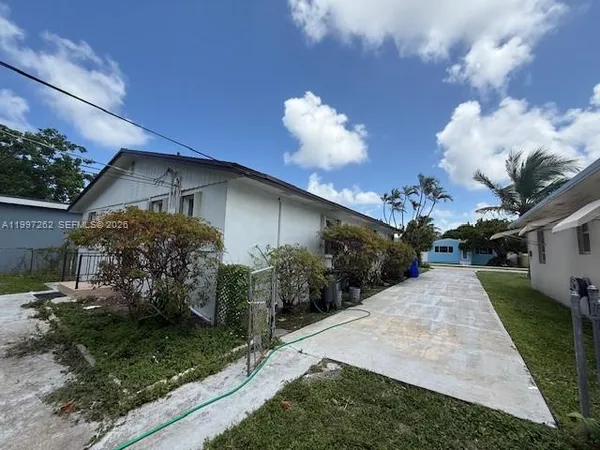 a front view of a house with a yard and a garage