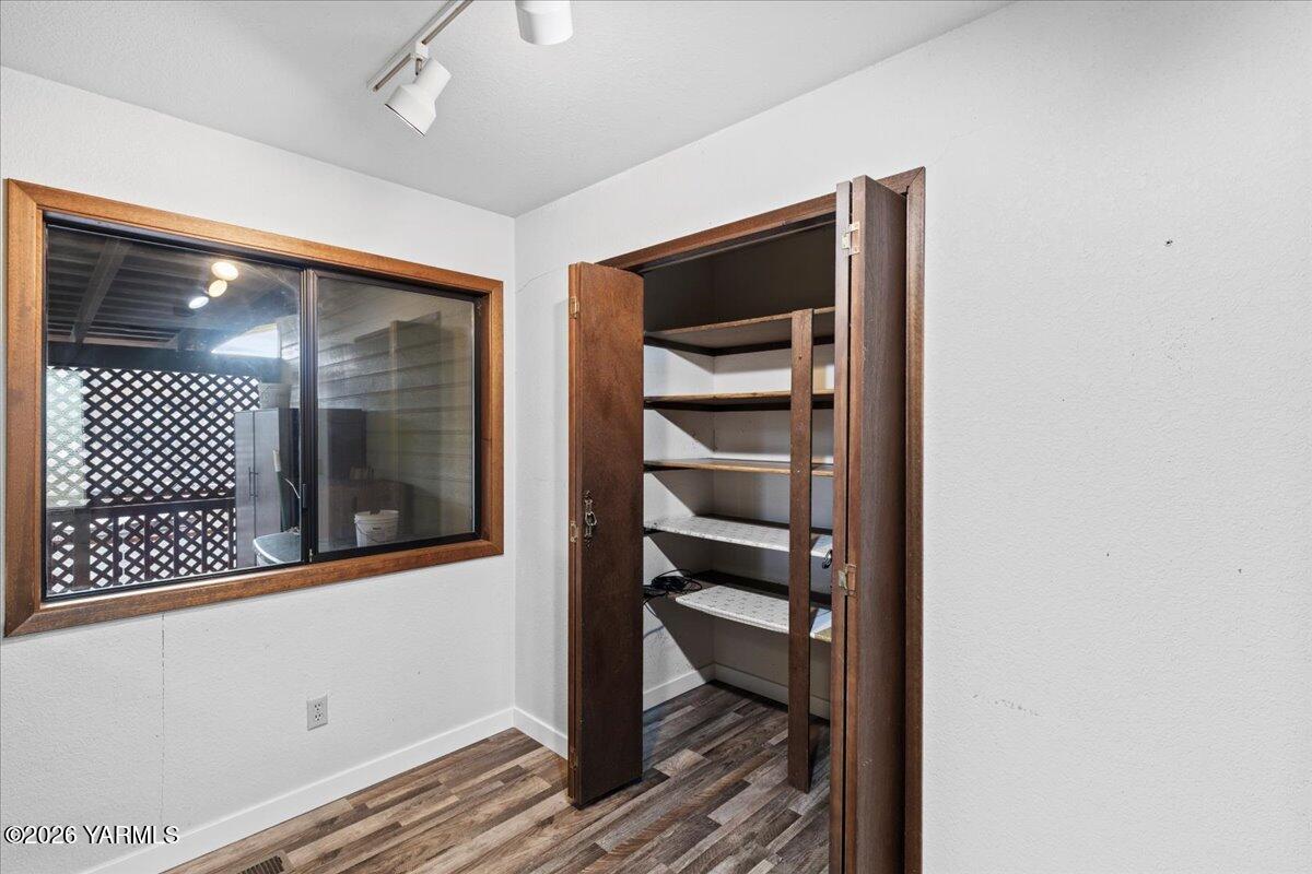 10802 Zier Road Yakima, WA 98908 - Photo 17 of 46 a view of a hallway with wooden floor and a bathroom