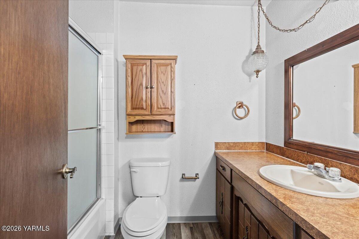 10802 Zier Road Yakima, WA 98908 - Photo 29 of 46 a bathroom with a granite countertop sink toilet and shower