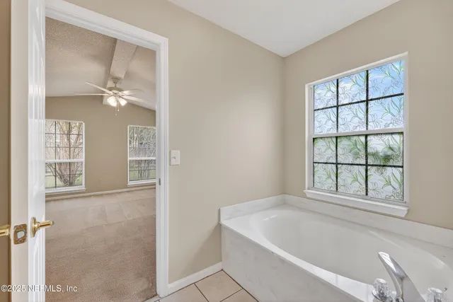 a bathroom with a bathtub and window