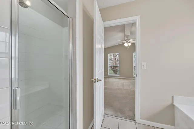 a bathroom with a glass shower door