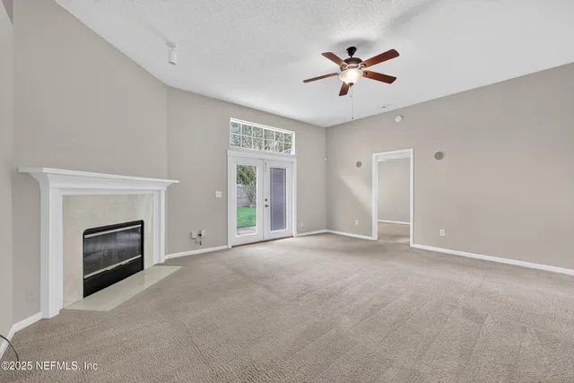 a view of an empty room with a fireplace