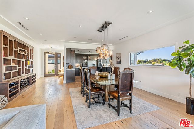 a view of a dining room with furniture and a potted plant