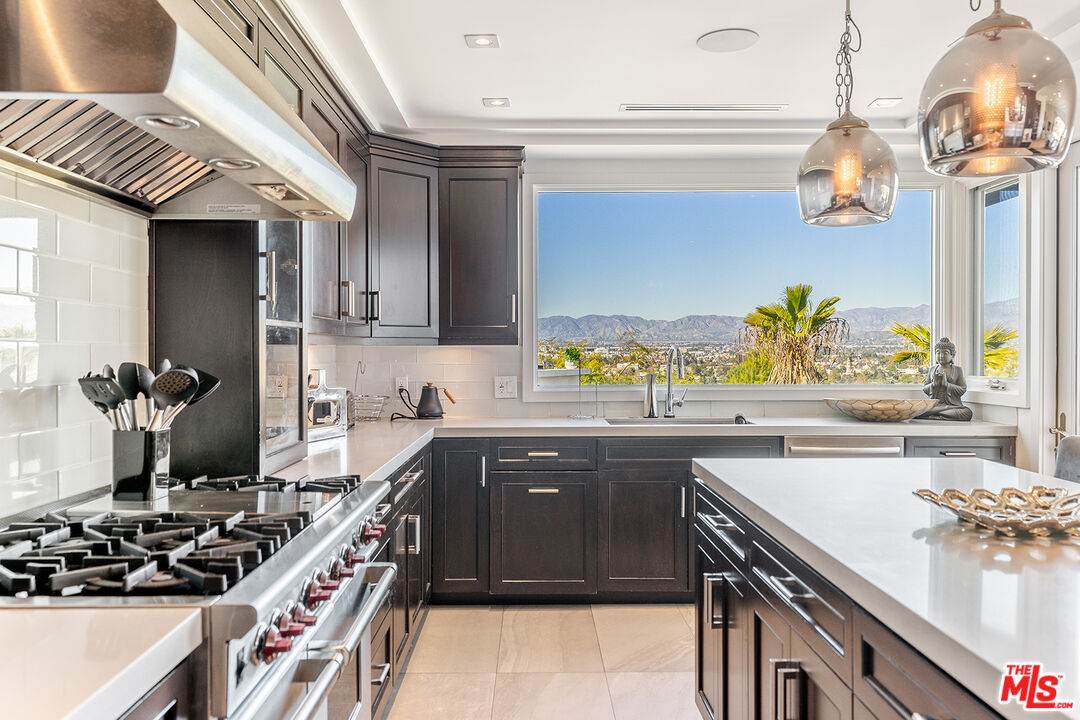10901 Terryview Drive Studio City, CA 91604 - Photo 15 of 50 a kitchen with a sink a stove and cabinets
