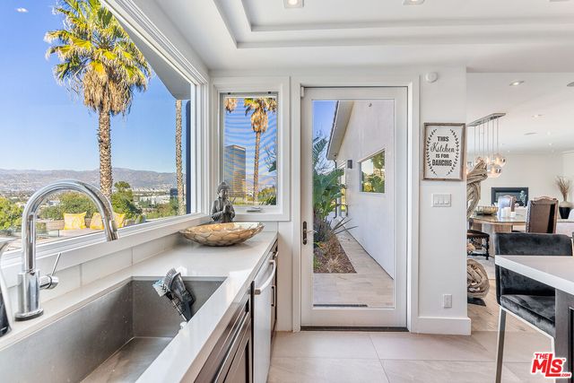 a view of living room with furniture and a potted plant