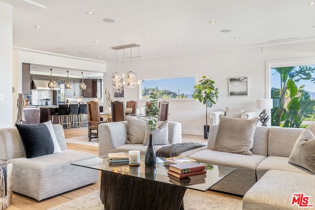 a living room with furniture and a chandelier