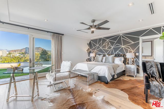 a bed room with a bed and a chandelier