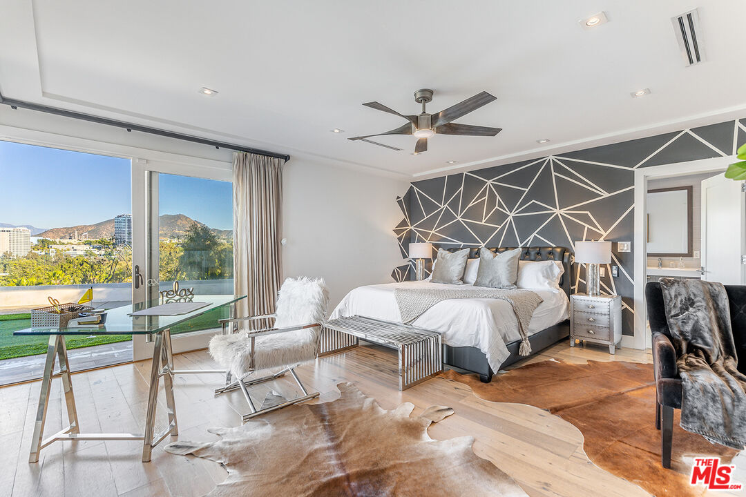 10901 Terryview Drive Studio City, CA 91604 - Photo 26 of 50 a bed room with a bed and a chandelier