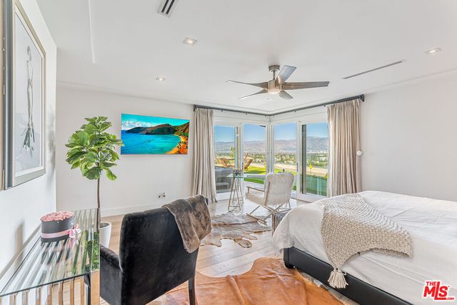 a living room with furniture flowerpot and a chandelier