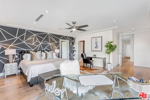 a bed room with a bed and a chandelier