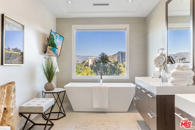 a white bath tub sitting next to a bathroom sink