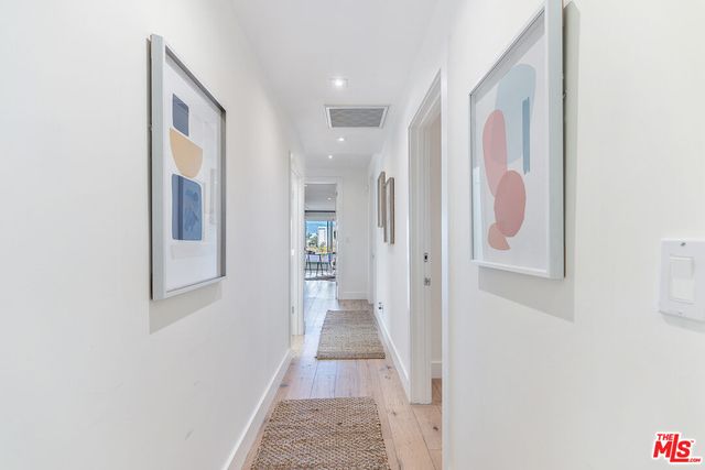 a view of hallway with wooden floor