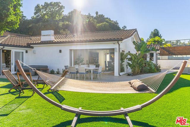 a view of a swimming pool with a patio and plants