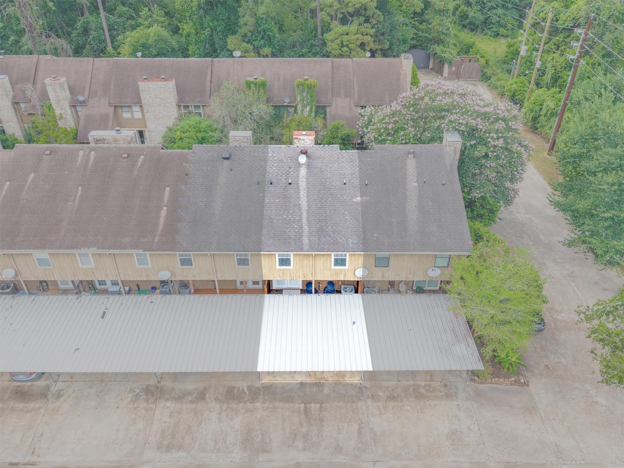 1011 Hamblen Road, Unit 306 Houston, TX 77339 - Photo 31 of 38 Here you can see the full row of townhomes along the community's covered carport, giving a clear sense of the layout and flow of the neighborhood.