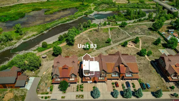 an aerial view of residential houses with outdoor space