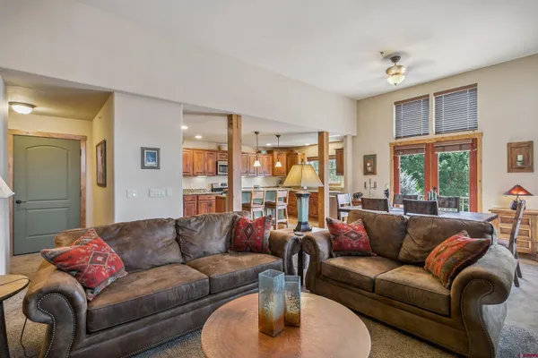 a living room with furniture and a lamp