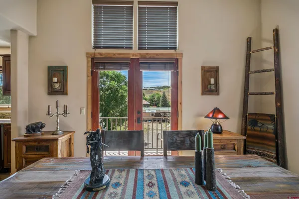a large kitchen with kitchen island a large window in it