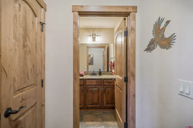 a bedroom with a bed and a dresser next to a window