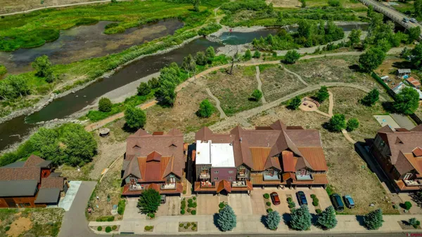 an aerial view of a house with a yard