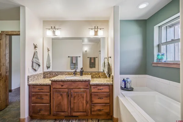 a bathroom with a bathtub and a shower
