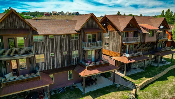 an aerial view of a house with swimming pool and porch
