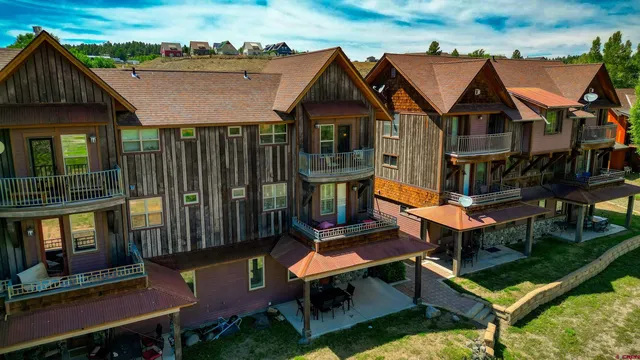 an aerial view of a house with swimming pool and porch