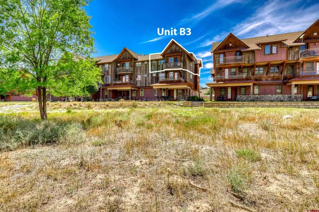 an aerial view of residential houses with outdoor space and street view