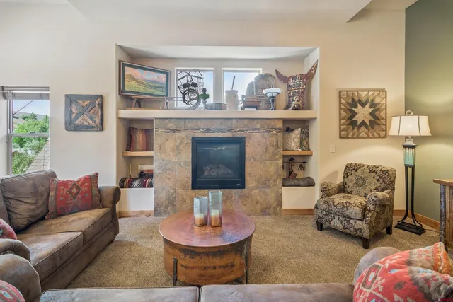 a living room with furniture and a fireplace
