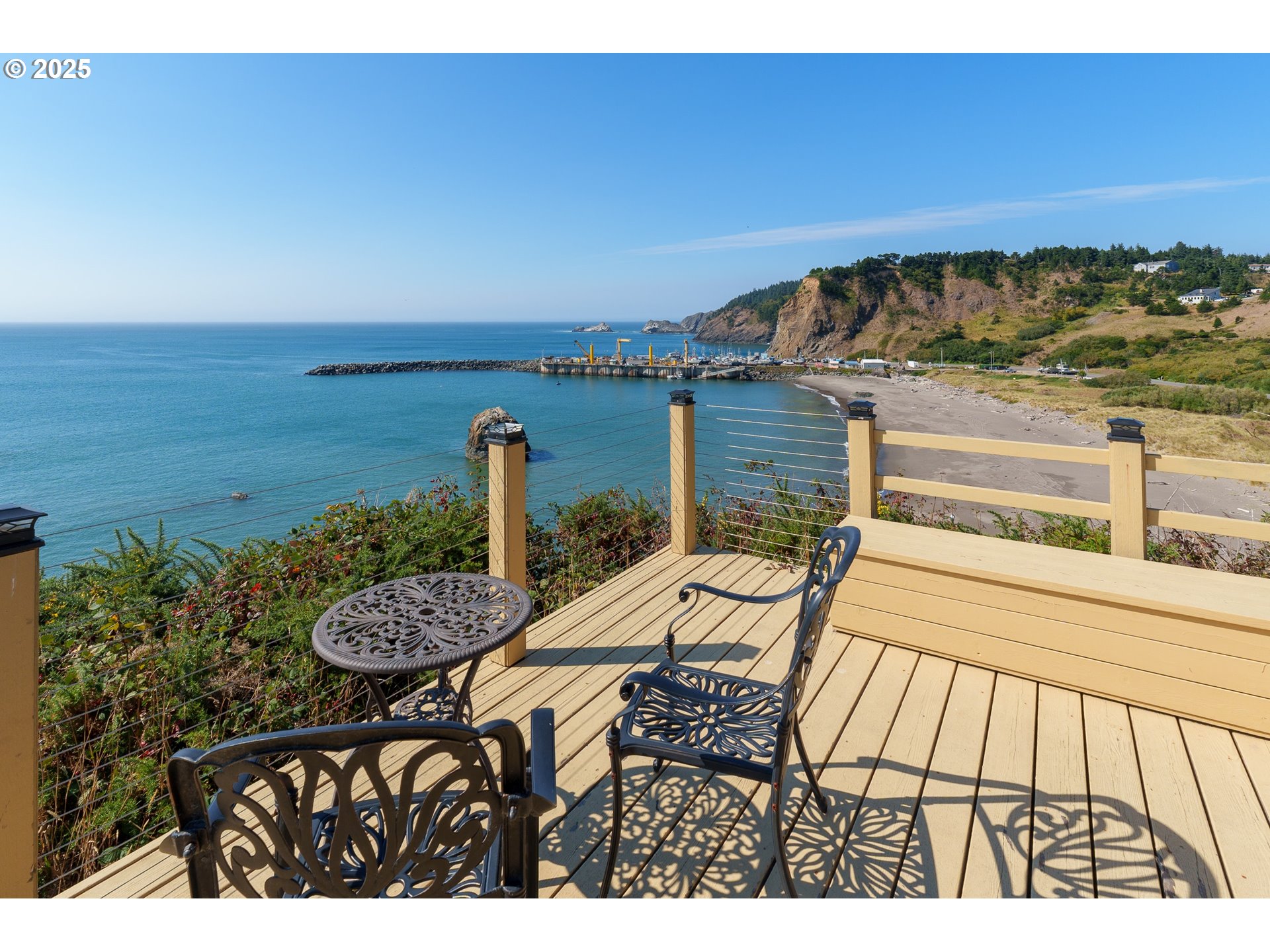 409 Jackson Street Port Orford, OR 97465 - Photo 11 of 48 a view of a balcony with chair and wooden floor