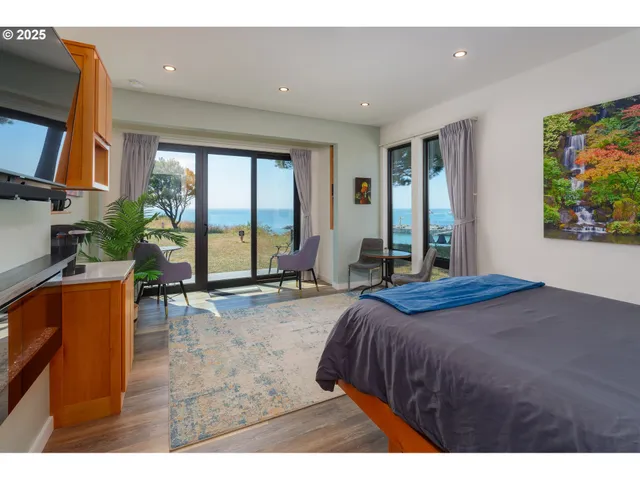 a bedroom with a bed and glass windows
