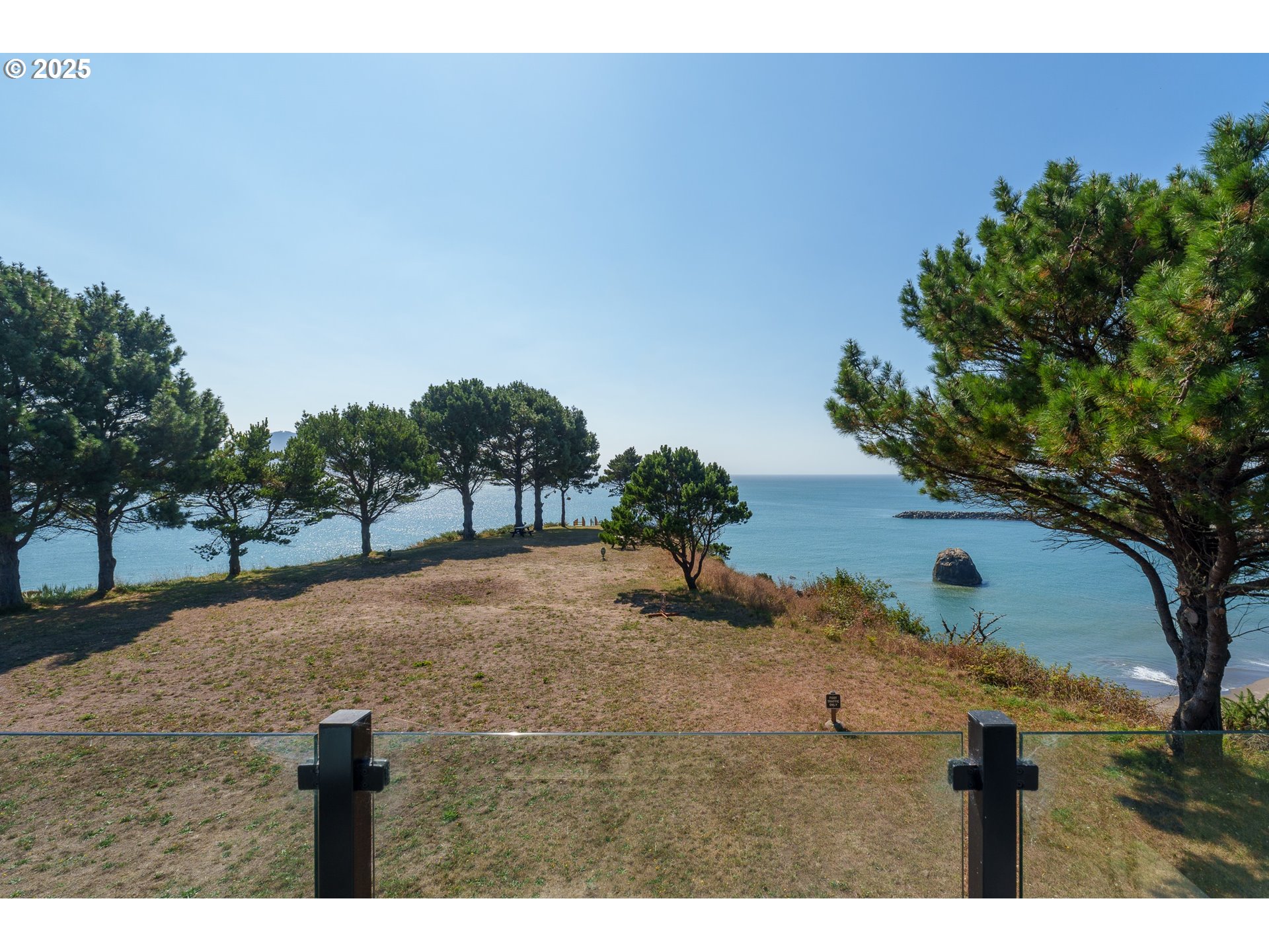 409 Jackson Street Port Orford, OR 97465 - Photo 24 of 48 a view of a yard with a tree