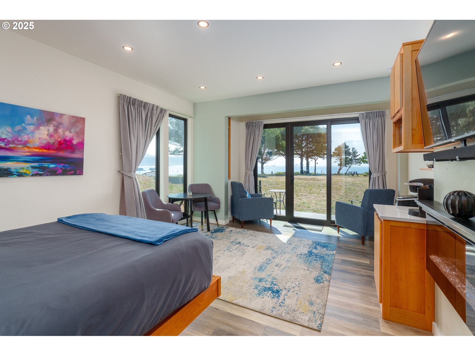 409 Jackson Street Port Orford, OR 97465 - Photo 26 of 48 a living room with furniture large window and flat screen tv