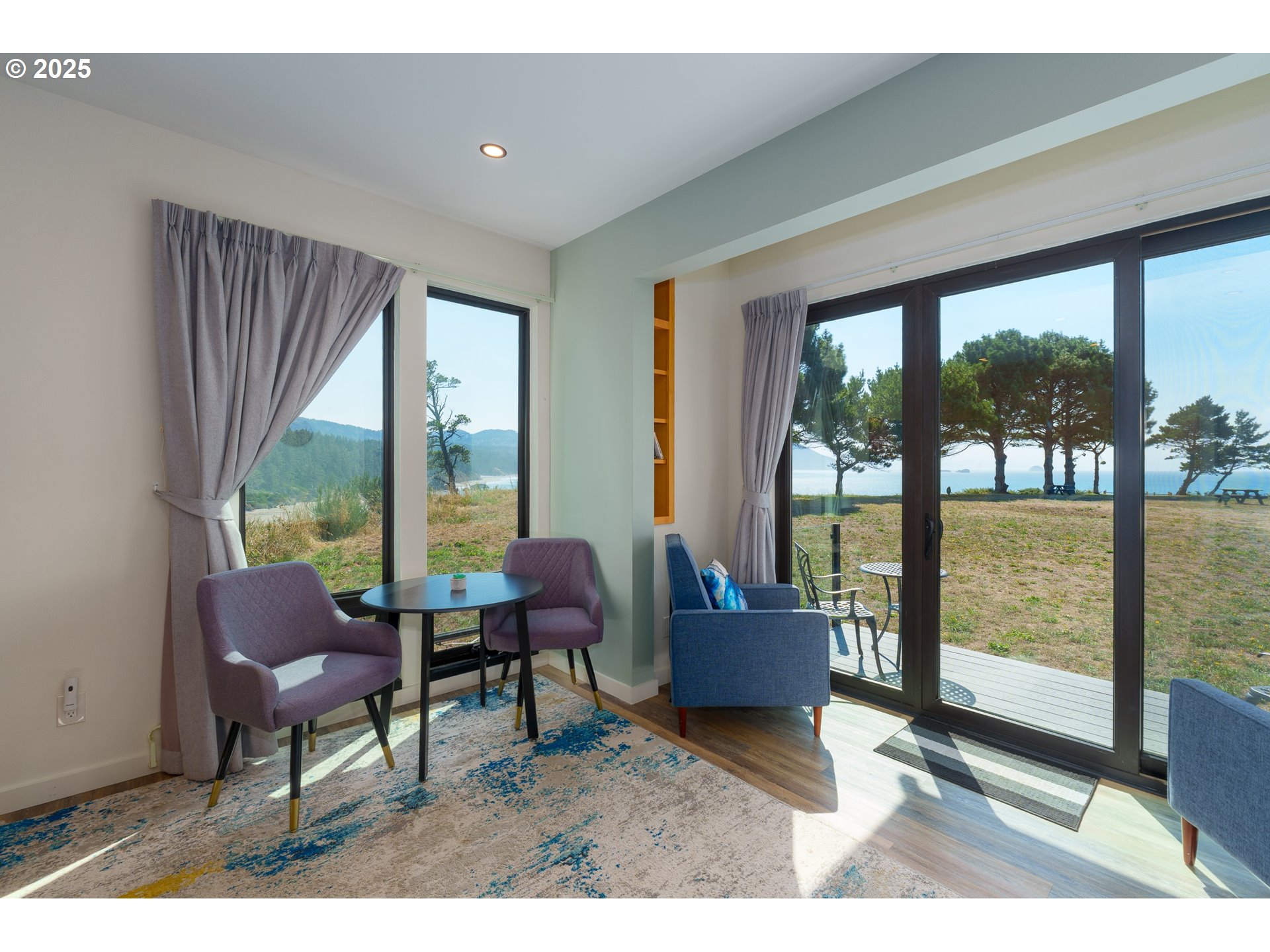 409 Jackson Street Port Orford, OR 97465 - Photo 27 of 48 a living room with furniture and a floor to ceiling window