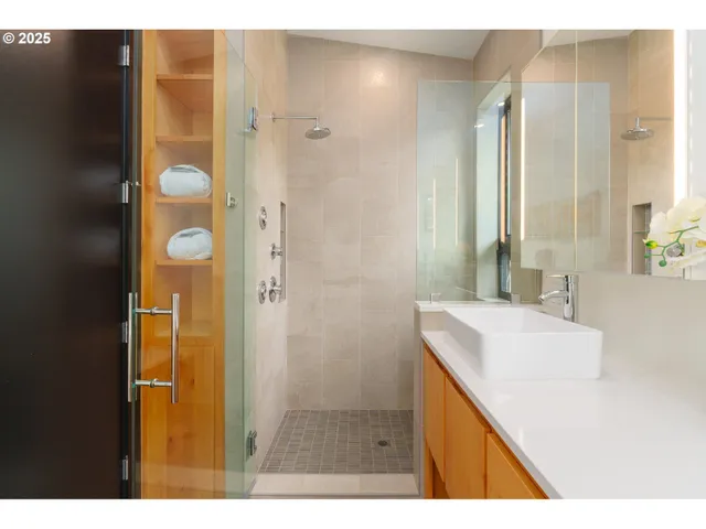 a bathroom with a sink a shower and a mirror