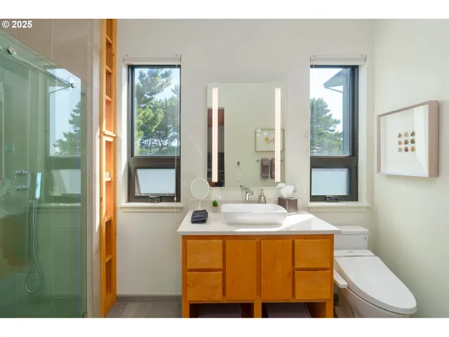 a bathroom with a sink a mirror and a shower