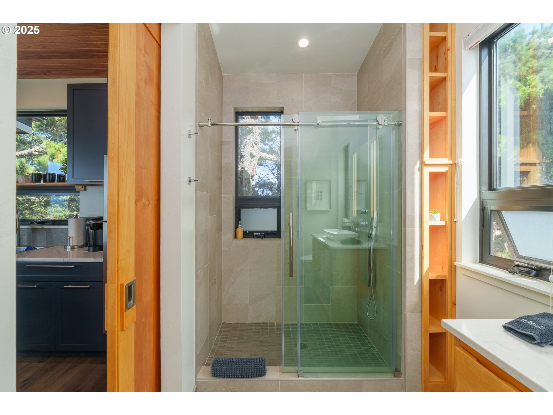 409 Jackson Street Port Orford, OR 97465 - Photo 45 of 48 a bathroom with a glass shower door