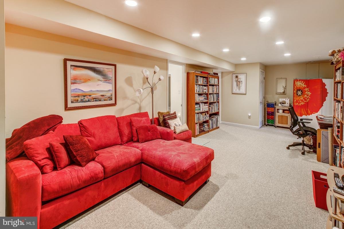 2225 Wakerobin Lane Reston, VA 20191 - Photo 23 of 30 a living room with furniture and a gym machine