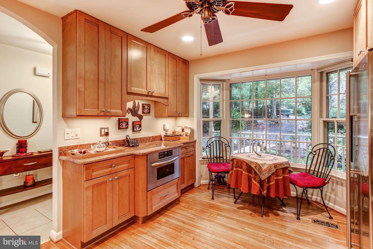2225 Wakerobin Lane Reston, VA 20191 - Photo 4 of 30 a kitchen that has a stove a table and chairs in it