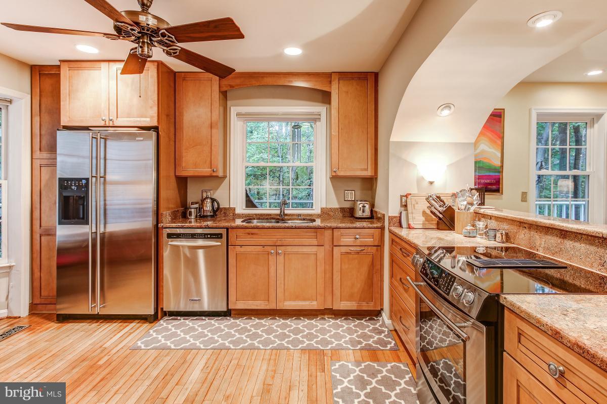 2225 Wakerobin Lane Reston, VA 20191 - Photo 5 of 30 a kitchen with stainless steel appliances granite countertop a sink stove and refrigerator