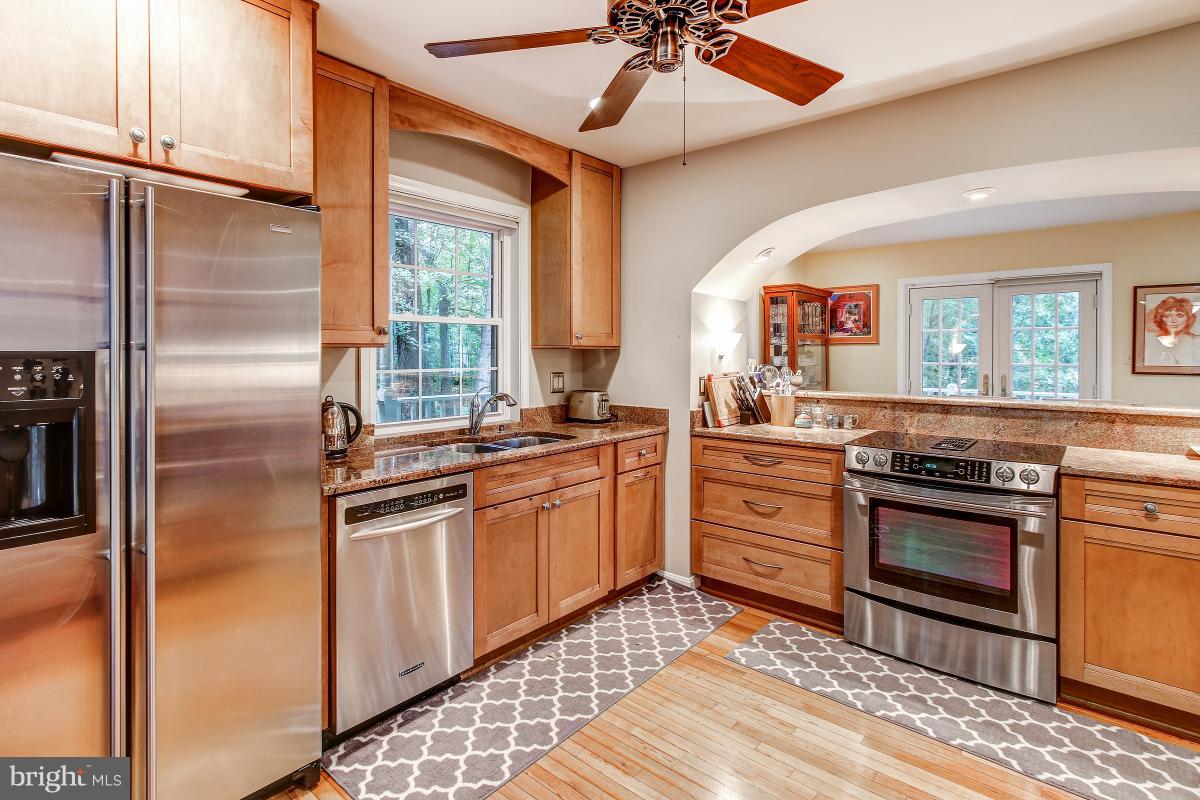 2225 Wakerobin Lane Reston, VA 20191 - Photo 6 of 30 a kitchen with stainless steel appliances granite countertop a stove a sink and a refrigerator