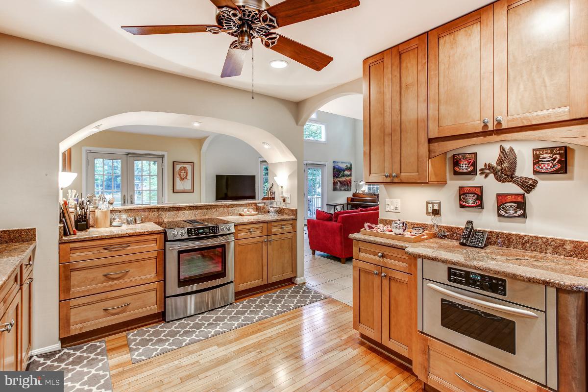 2225 Wakerobin Lane Reston, VA 20191 - Photo 7 of 30 a kitchen with stainless steel appliances granite countertop a stove a sink and a refrigerator