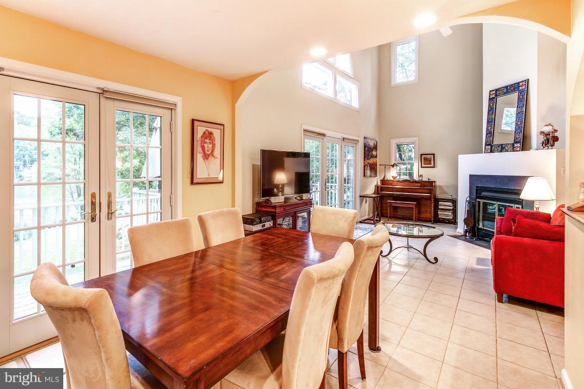 2225 Wakerobin Lane Reston, VA 20191 - Photo 9 of 30 a living room with furniture a fireplace and a large window