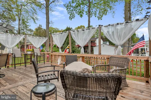 an aerial view of a house with a yard basket ball court and outdoor seating