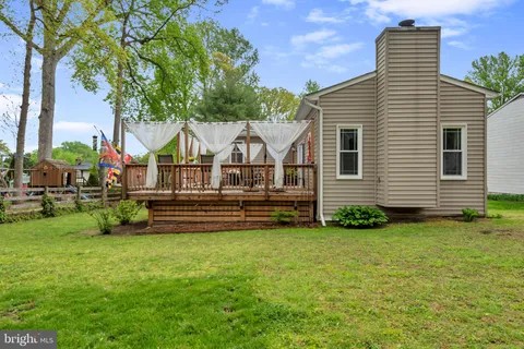a view of a chairs and table in backyard of the house