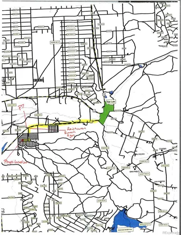 a picture of white wall with a vase and flowers in front of it