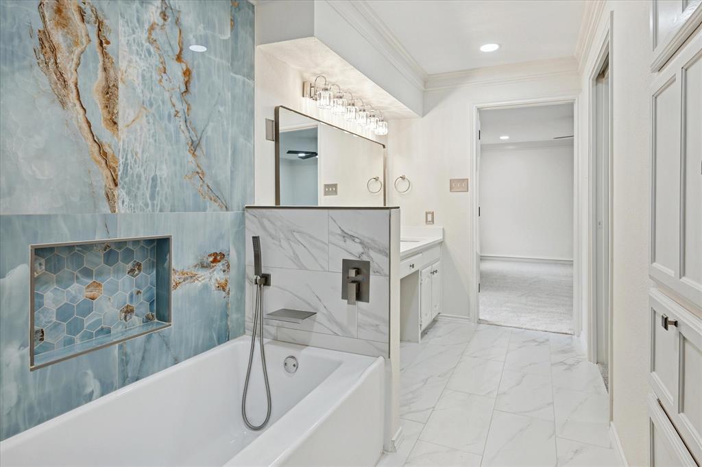 62 Legend Road Benbrook, TX 76132 - Photo 14 of 27 Beautiful primary ensuite bath features designer accents by the separate tub and shower, double sinks and spacious walk-in closet.